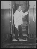 Alfred MacMillian, Pullman Porter waiting for a train to start aboard the "Capitol Limited" bound for Chicago Illinois.